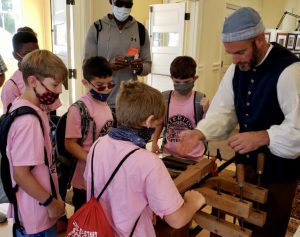 students observing woodworker