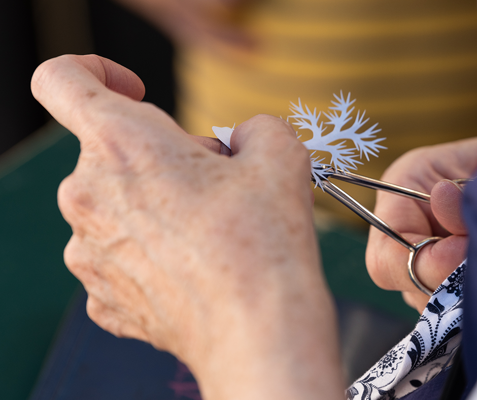 Waterford Fair artisan cutting a paper design